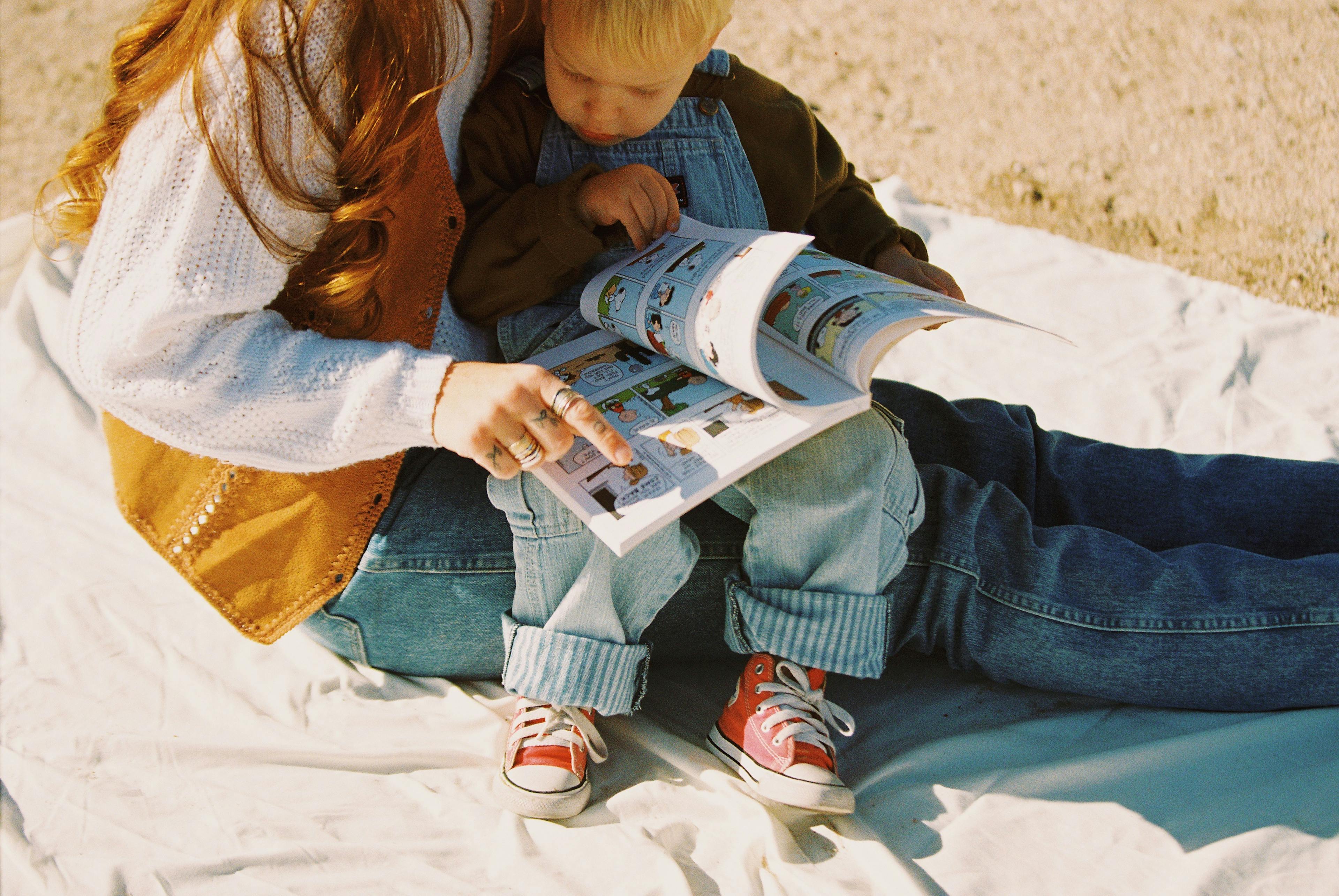 Woman reading to her son on a lake beach in Arizona, captured on film by Natalie Carrasco
